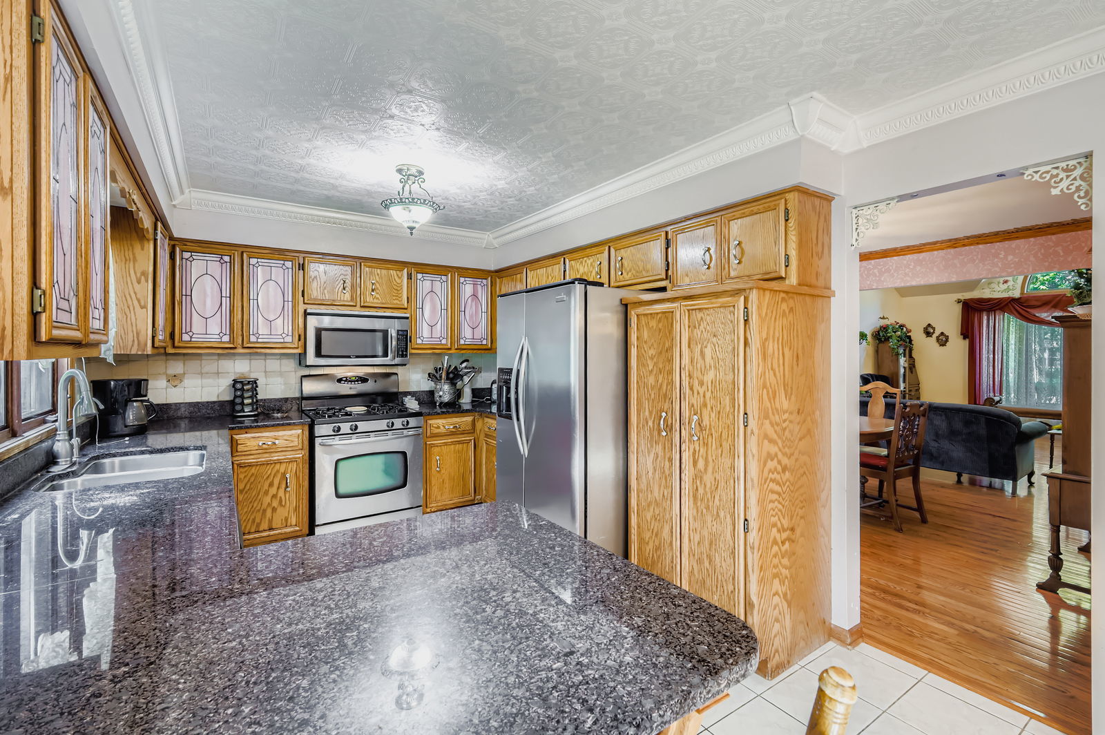 10785 Ashford Avenue Frankfort, IL 60423 - Photo 11 of 42 a kitchen with stainless steel appliances granite countertop a refrigerator a stove top oven and a sink with granite countertops