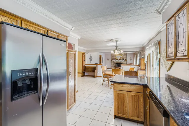 a kitchen with stainless steel appliances granite countertop a refrigerator and a sink