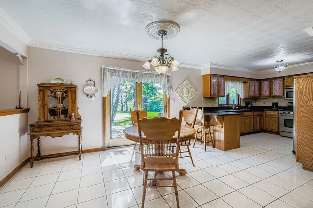 a view of a dining room with furniture and a chandelier