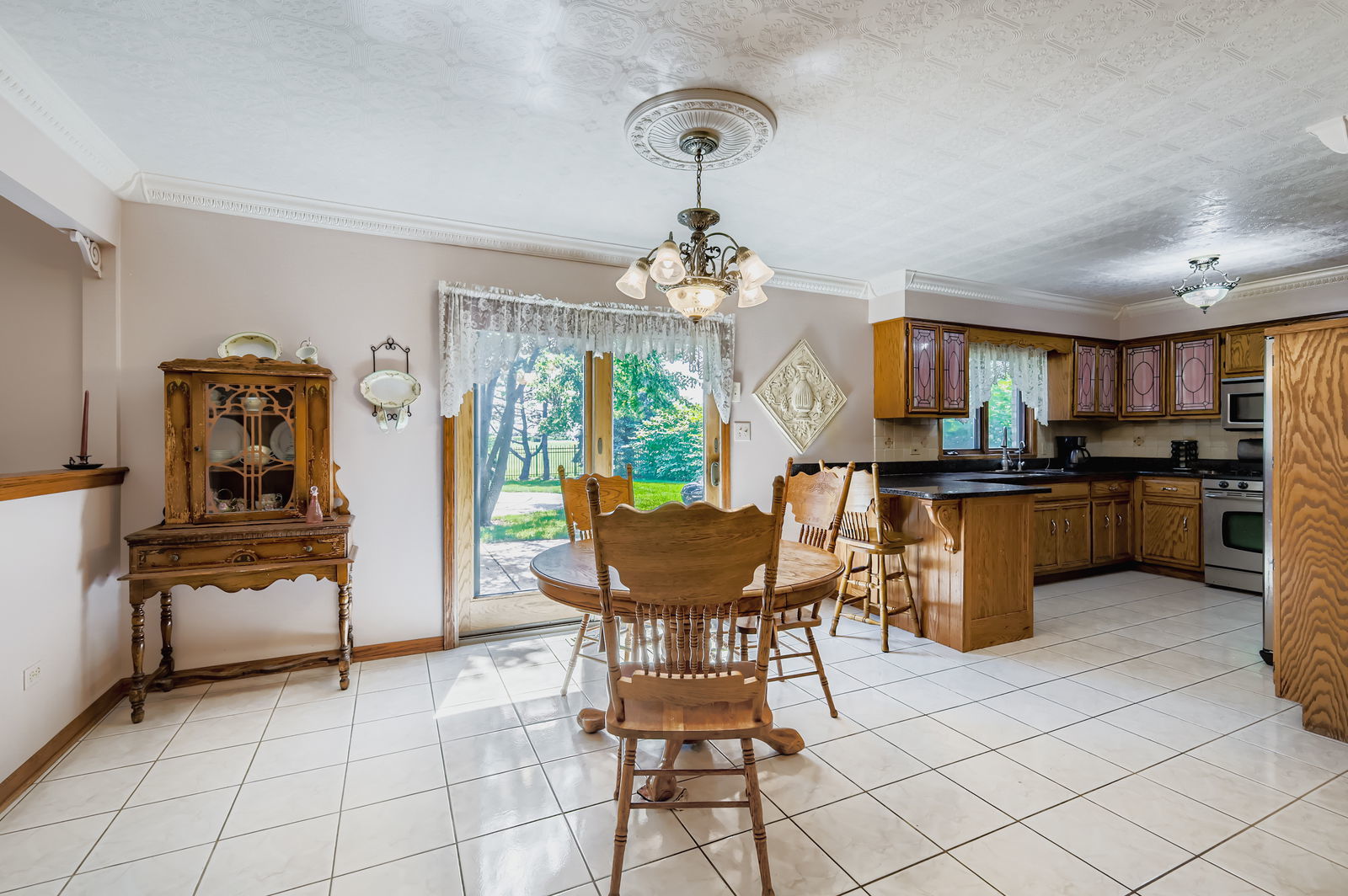 10785 Ashford Avenue Frankfort, IL 60423 - Photo 14 of 42 a view of a dining room with furniture and a chandelier