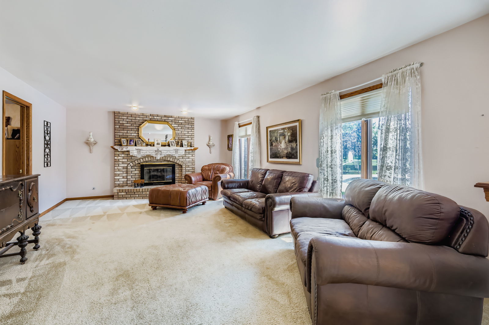 10785 Ashford Avenue Frankfort, IL 60423 - Photo 15 of 42 a living room with furniture a fireplace and a flat screen tv