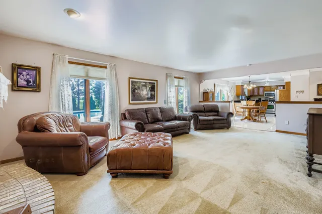 a living room with furniture large window and a table