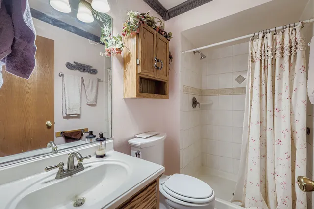 a bathroom with a sink toilet and shower