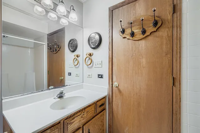 a bathroom with a sink a mirror and a shower curtain