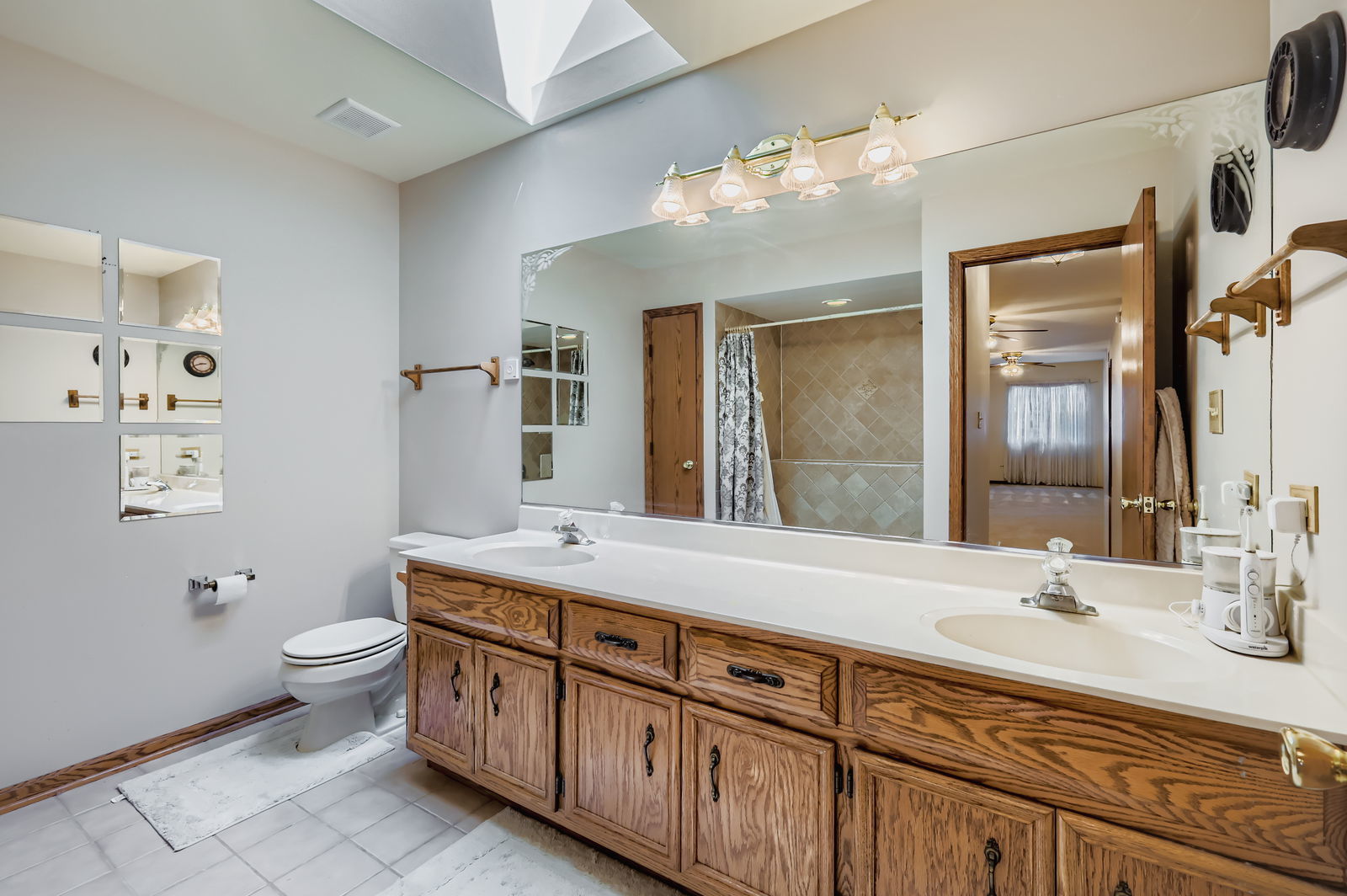 10785 Ashford Avenue Frankfort, IL 60423 - Photo 26 of 42 a bathroom with a granite countertop double vanity sink mirror and toilet