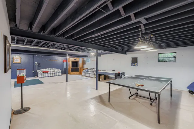 a room with table tennis and arcade game machine