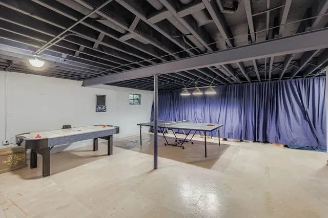 a view of a room with table tennis table and wooden walls