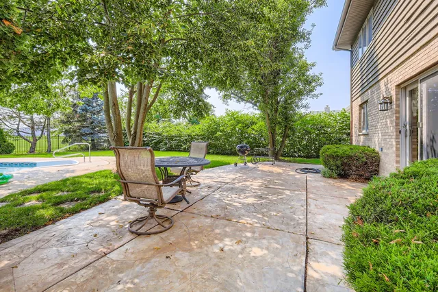 a view of a bench in a backyard of a house