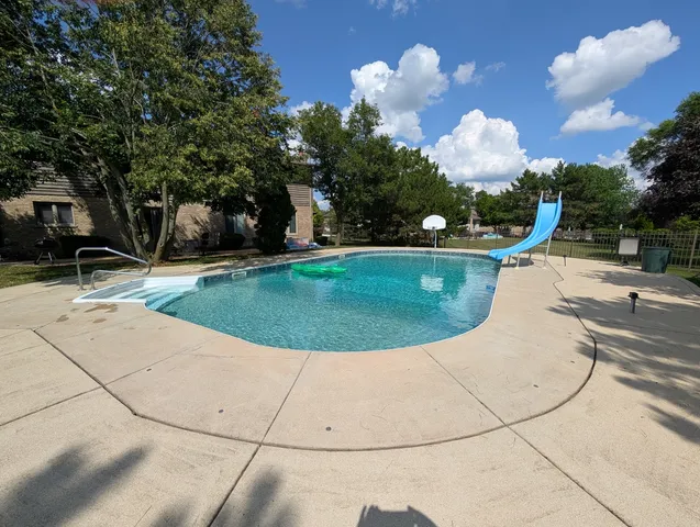 a view of a swimming pool with a yard