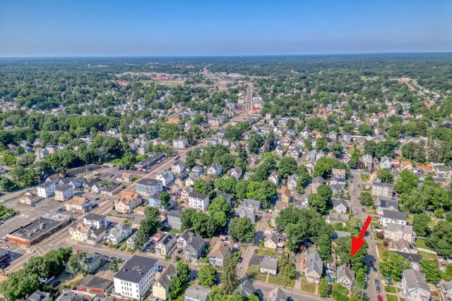 an aerial view of a houses with a yard