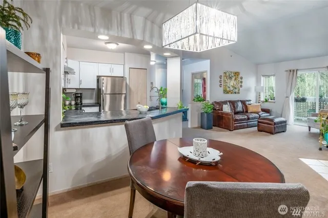 a dining room with furniture a chandelier and window