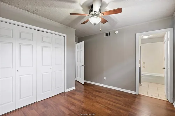 a view of an empty room with wooden floor