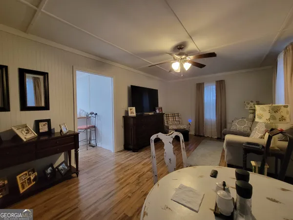 a view of a livingroom with furniture and a flat screen tv
