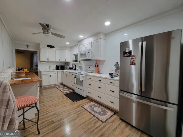 a kitchen with stainless steel appliances a refrigerator stove microwave and cabinets