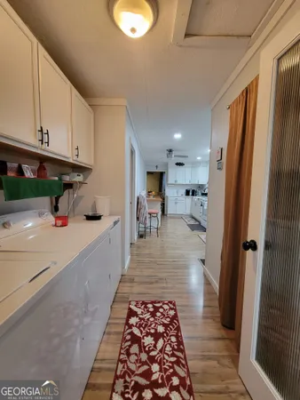 a kitchen with granite countertop a refrigerator and a sink