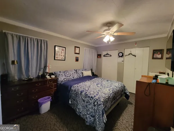 a bedroom with a bed and a chandelier