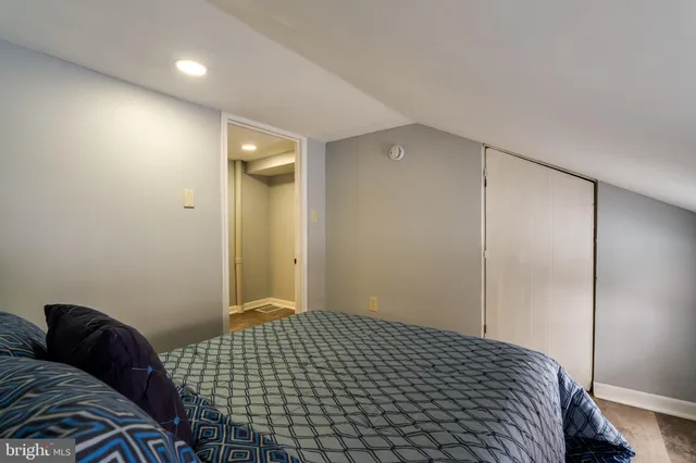 a bedroom with a bed and a walk in closet