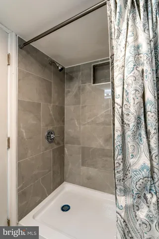 a bathroom with a shower and a sink