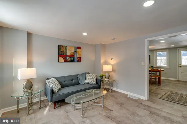 a living room with furniture and a lamp