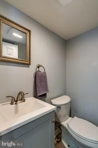 a bathroom with a sink a toilet and mirror