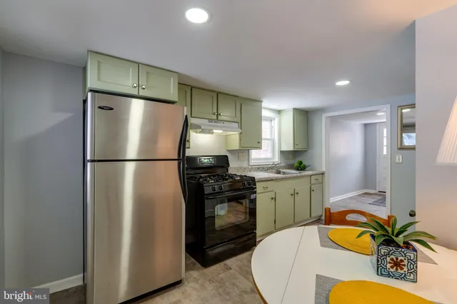 a kitchen with a refrigerator and a sink