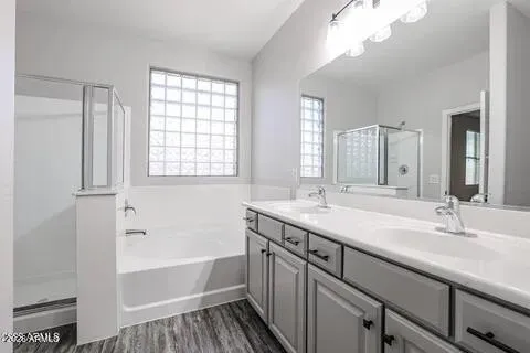 a bathroom with a sink a large mirror and a bathtub