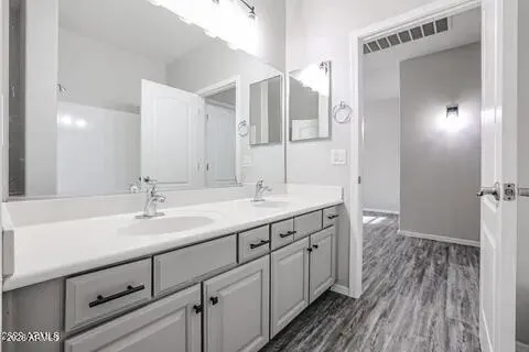a bathroom with a double vanity sink and mirror