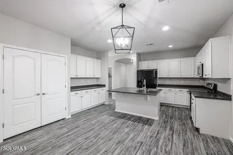 a kitchen with stainless steel appliances granite countertop a stove and refrigerator