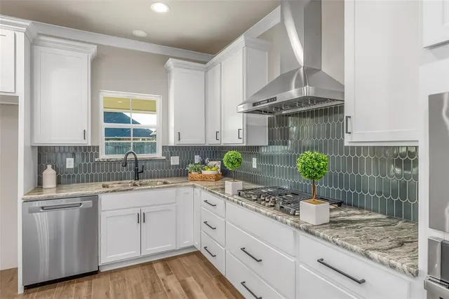 a kitchen with a sink a stove cabinets and counter space
