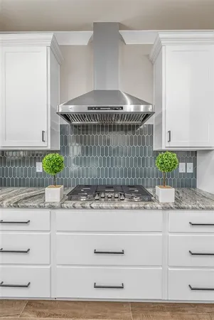 a stove top oven sitting inside of a kitchen