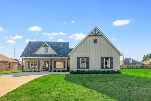 a front view of a house with a yard and porch