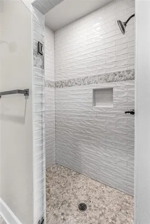 an empty room with a window and a ceiling fan