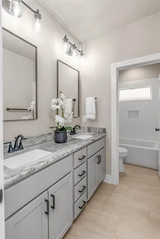 a bathroom with a bathtub toilet and shower