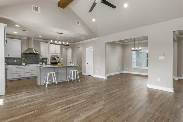 a large kitchen with a table and chairs