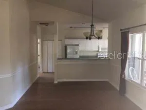 a kitchen with a refrigerator and window