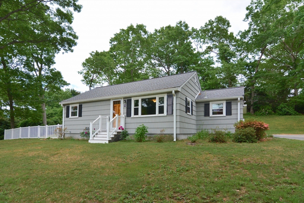 a front view of house with yard and trees