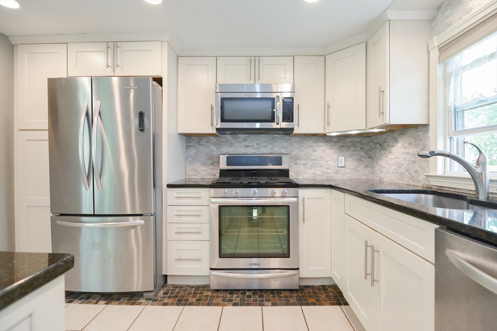 48 Smiths Lane Kingston, MA 02364 - Photo 11 of 38 a kitchen with granite countertop a refrigerator and a sink
