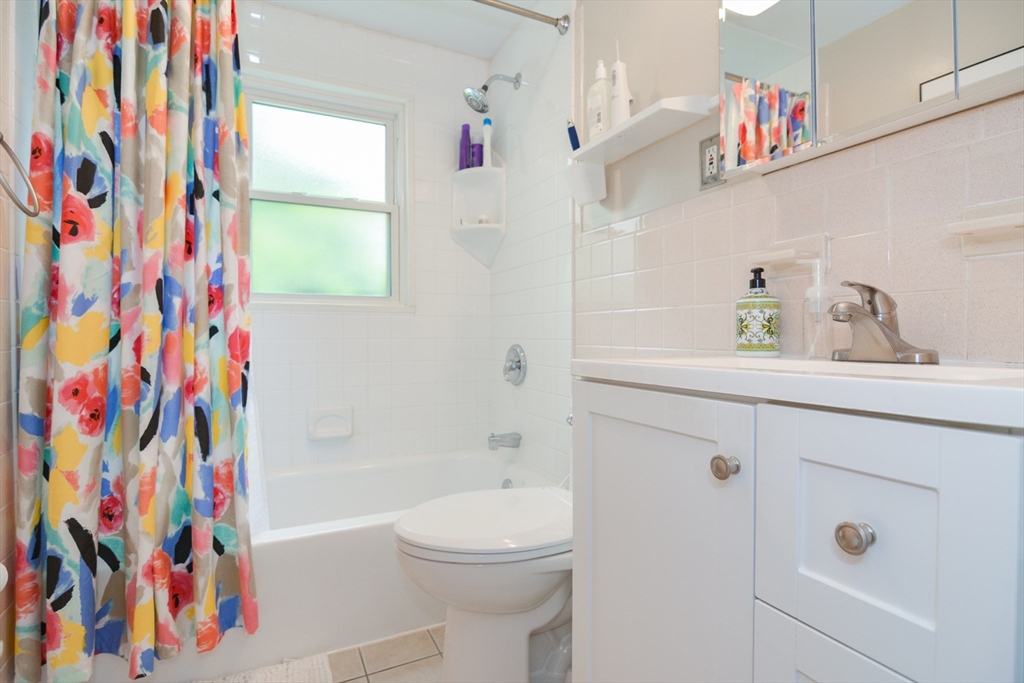48 Smiths Lane Kingston, MA 02364 - Photo 20 of 38 a bathroom with a sink a toilet and a shower curtain