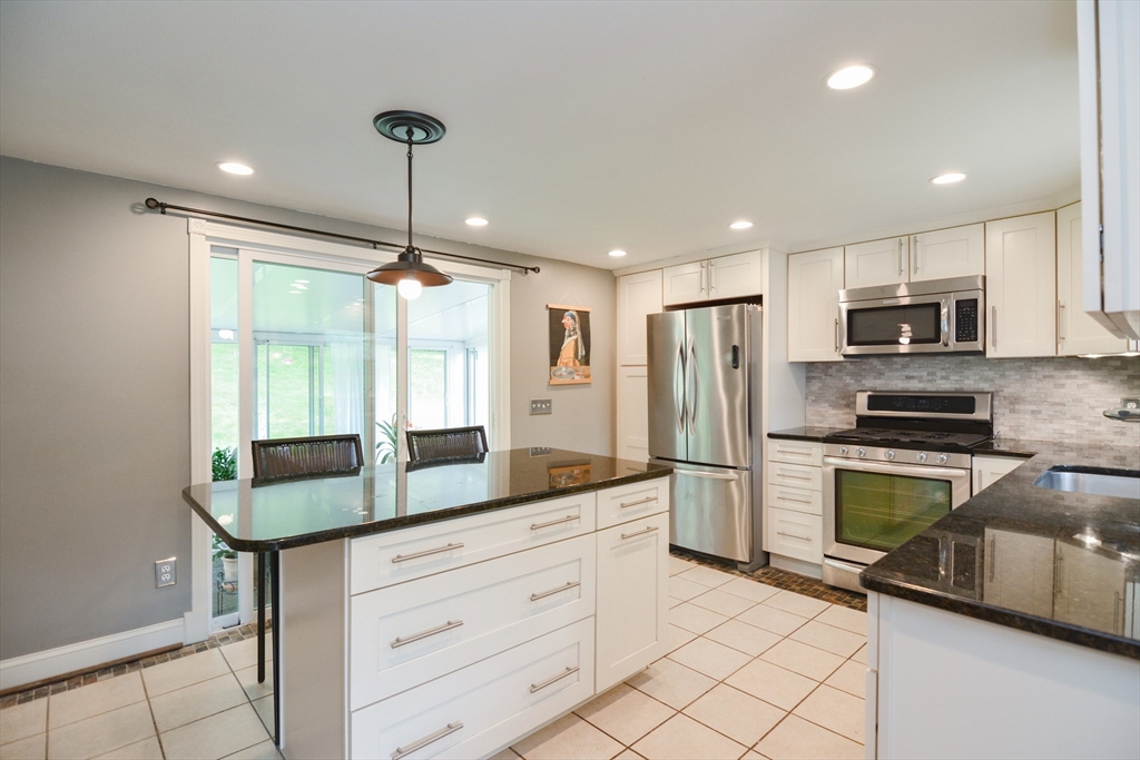 48 Smiths Lane Kingston, MA 02364 - Photo 6 of 38 a kitchen with kitchen island granite countertop appliances cabinets and a counter top space