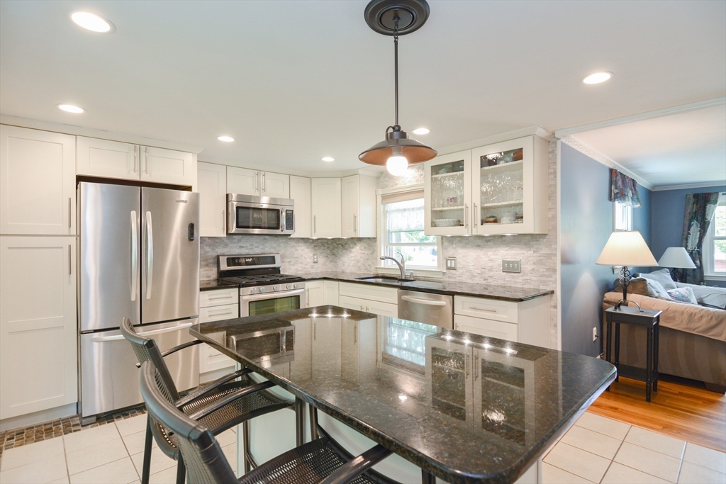 48 Smiths Lane Kingston, MA 02364 - Photo 7 of 38 a kitchen with stainless steel appliances granite countertop a stove refrigerator sink and cabinets