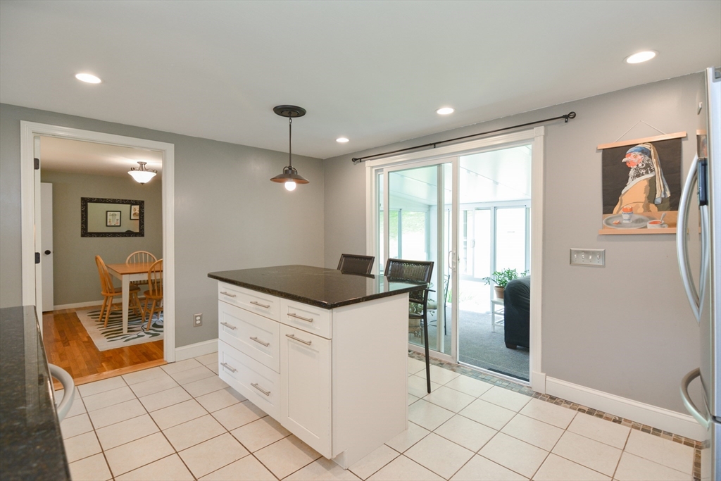 48 Smiths Lane Kingston, MA 02364 - Photo 9 of 38 a kitchen with granite countertop a refrigerator and a sink