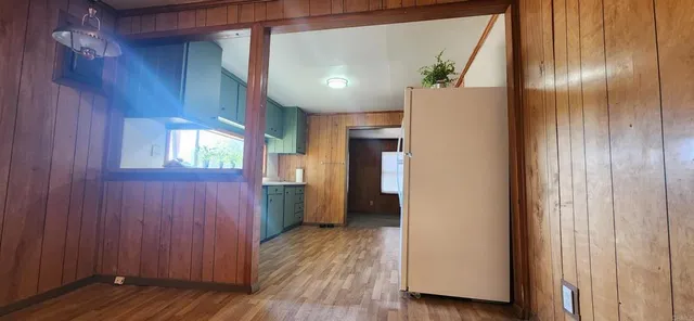 a view of hallway with wooden floor and staircase