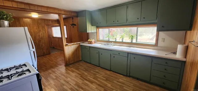 a kitchen with a sink stove and refrigerator