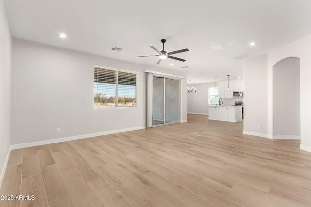 a view of a kitchen with wooden floor and a ceiling fan