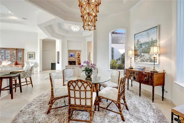 a living room with furniture a flat screen tv and a large window