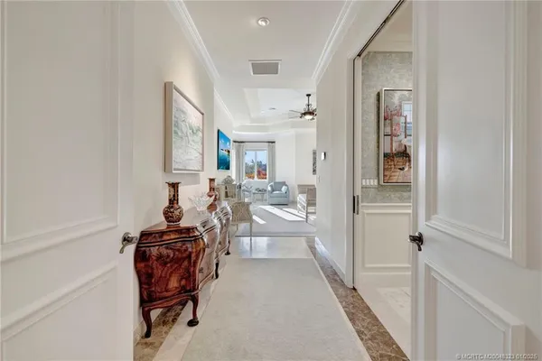 a spacious bedroom with a bed a mirror and lamp