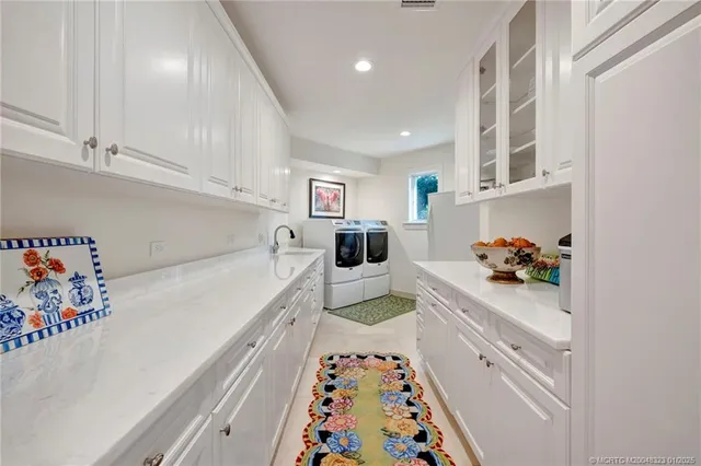 a living room with furniture and large windows