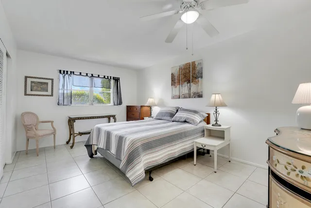 a spacious bedroom with a bed and a chandelier