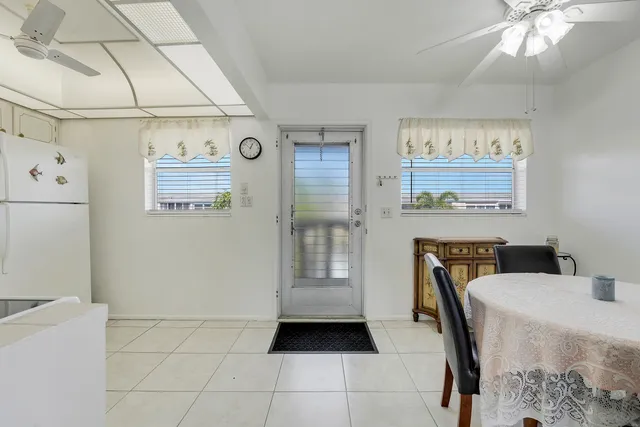 a kitchen with a refrigerator and a stove top oven