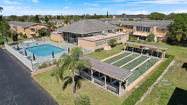 an aerial view of a house with a big yard
